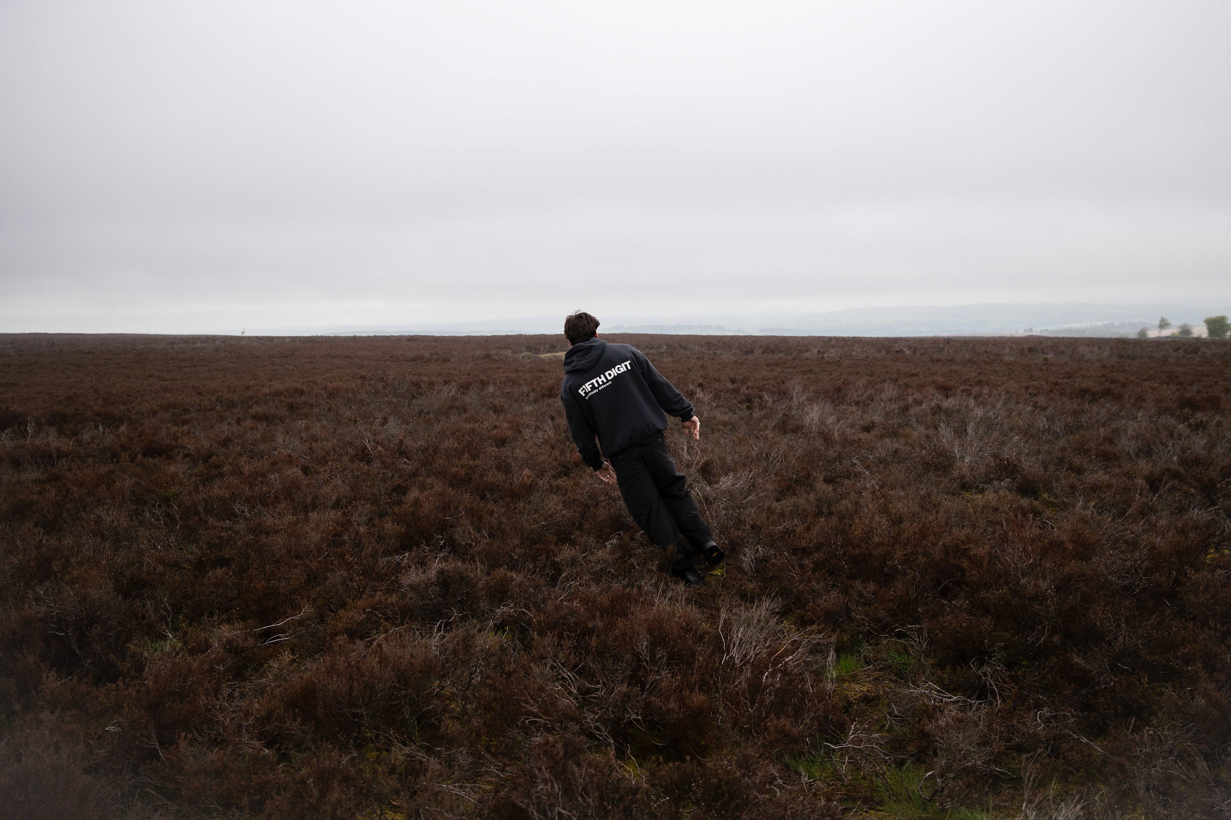 Fifth Digit Capsule 001 — Frame hoodie, leaning on moorland, Peak District