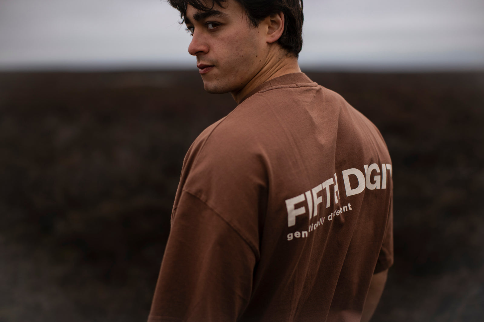 Fifth Digit Capsule 001 — vintage brown tee, FIFTH DIGIT back print, figure looking back