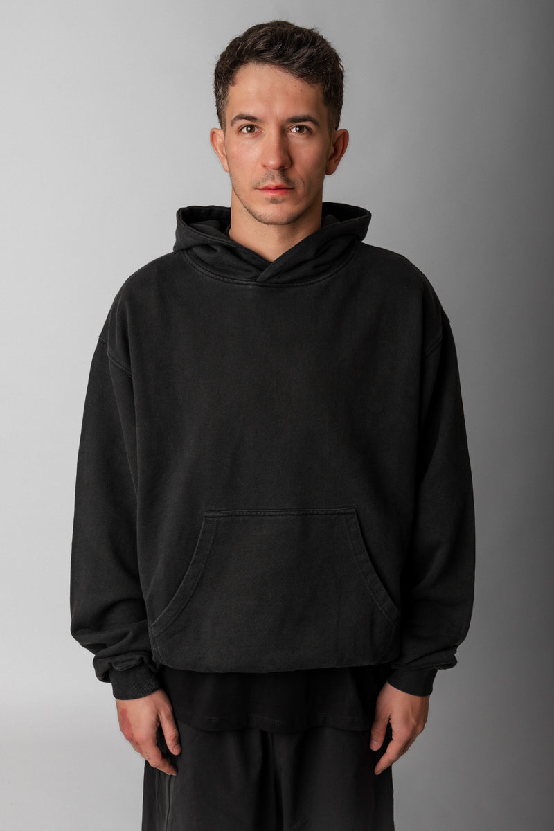 Model wearing Fifth Digit Frame 460gsm organic cotton hoodie in vintage black, front view