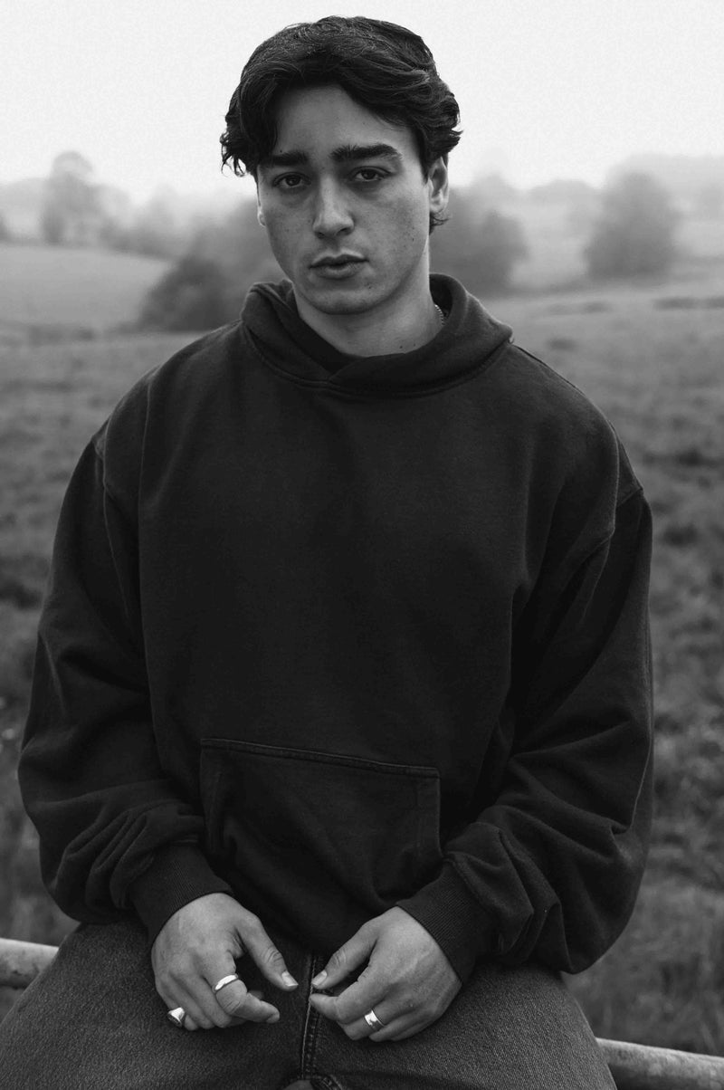 Model wearing Fifth Digit Frame 460gsm organic cotton hoodie in vintage black, front view