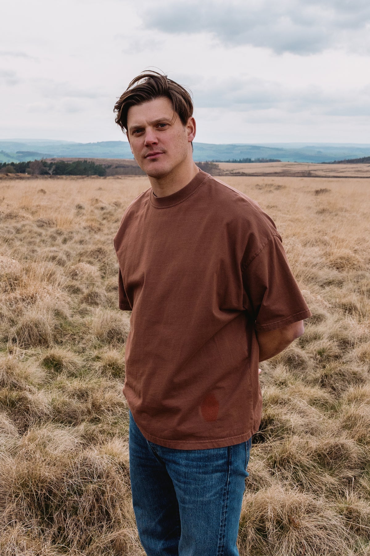 Fifth Digit founder James Harris, outdoor portrait wearing Pressure 240gsm organic cotton tee in vintage brown