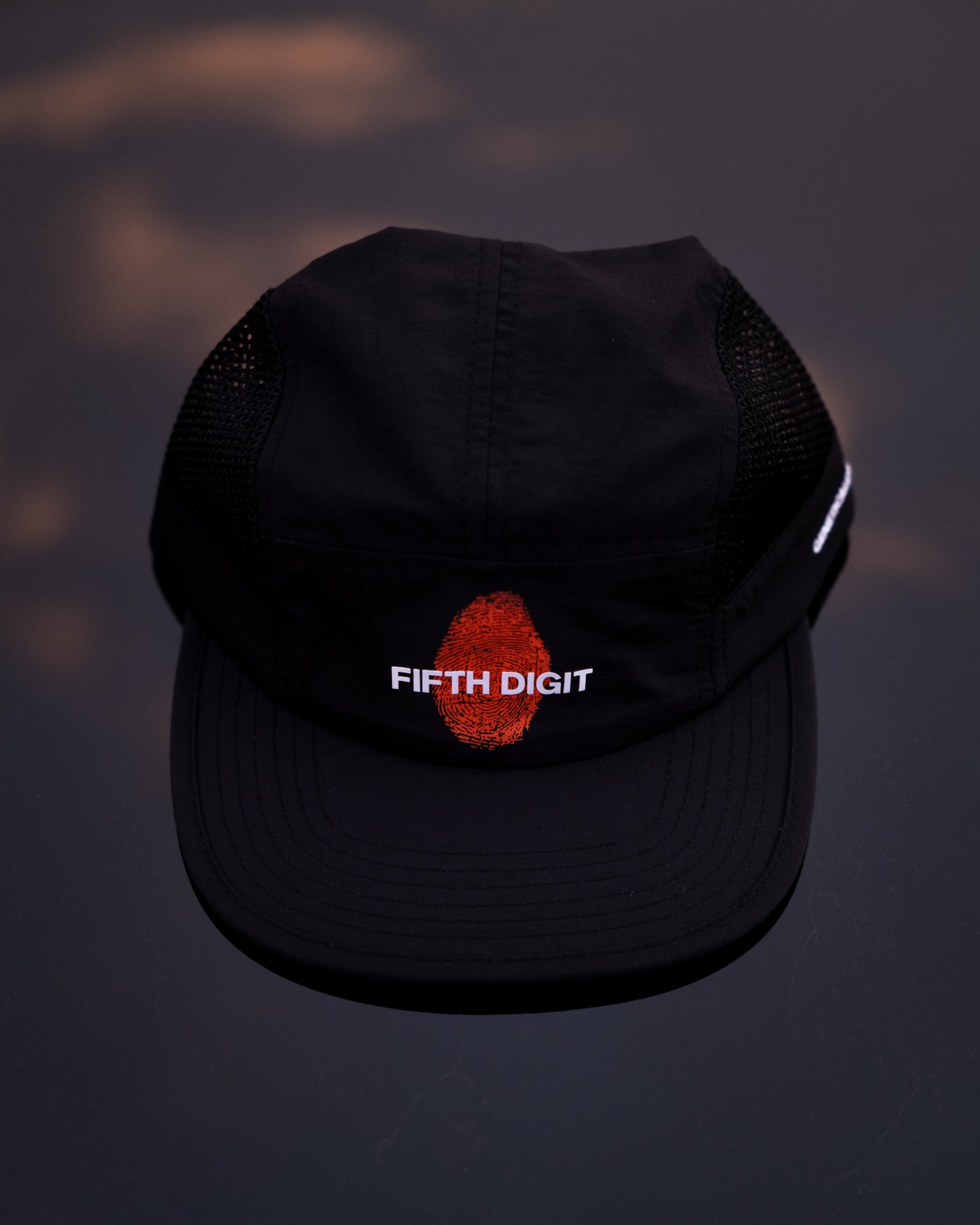 Fifth Digit Runner structured cap in black, flat lay front showing thumbprint embroidery and FIFTH DIGIT text