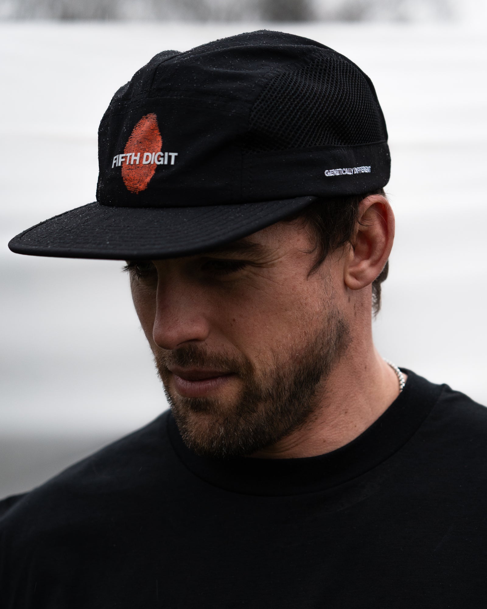 Model wearing Fifth Digit Runner structured cap in black, side view
